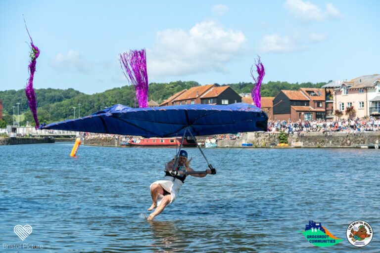Birdman flying over harbour